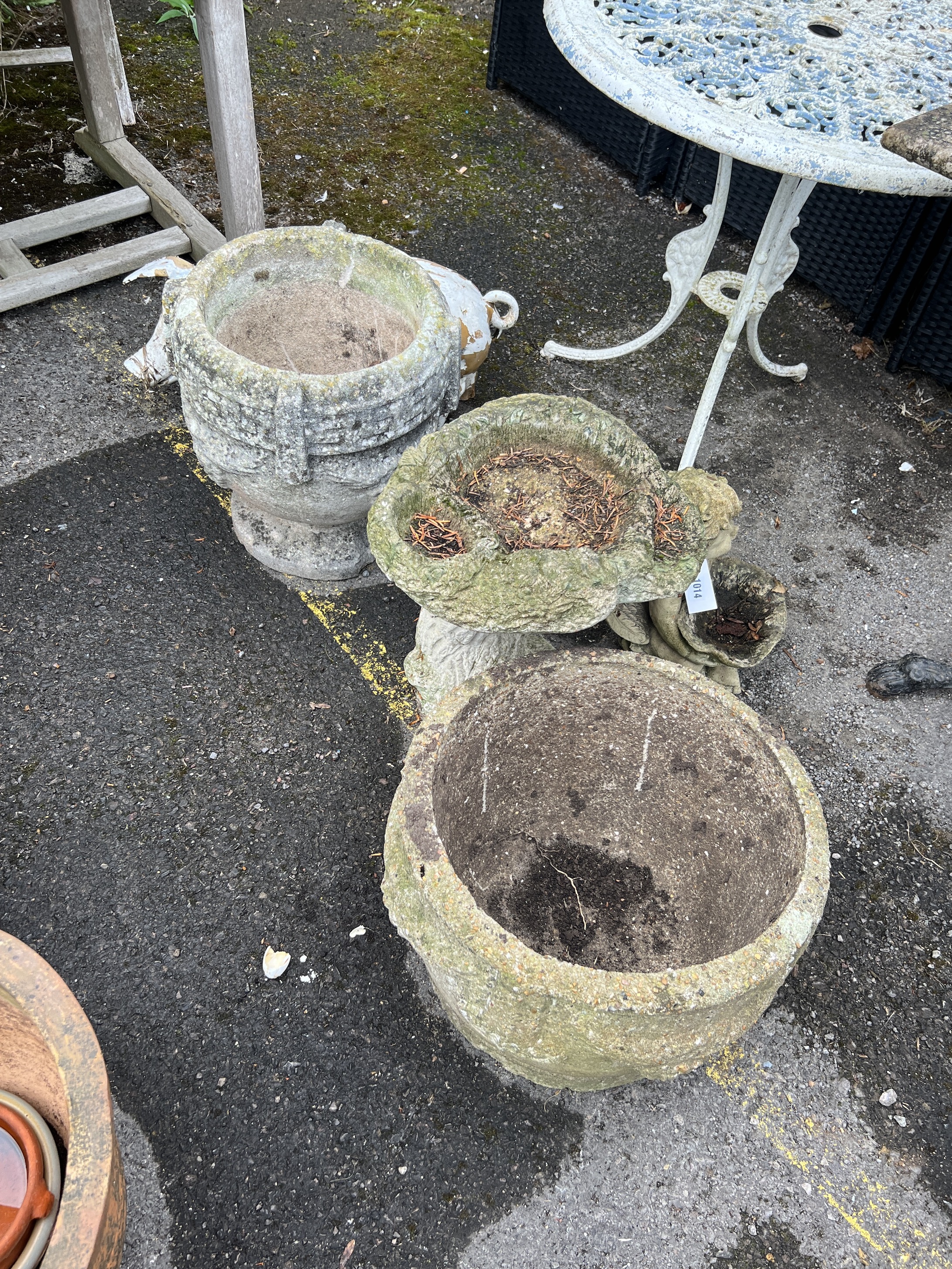 Two reconstituted stone garden planters, larger diameter 40cm, height 30cm, two bird baths and two ornaments